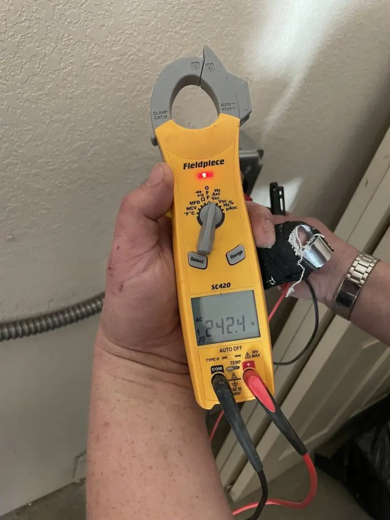 Voltage testing with clamp meter during Outlet Installation in Lead